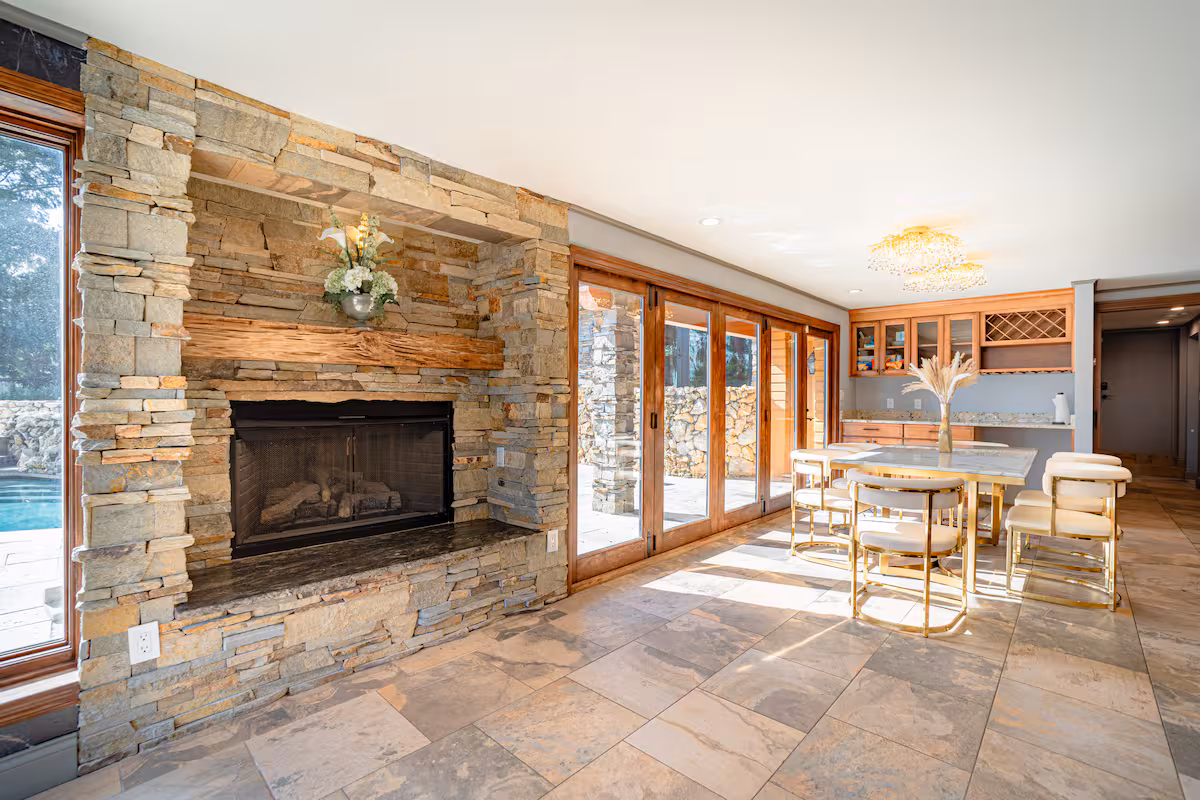 Stone fireplace dining hall with timber table