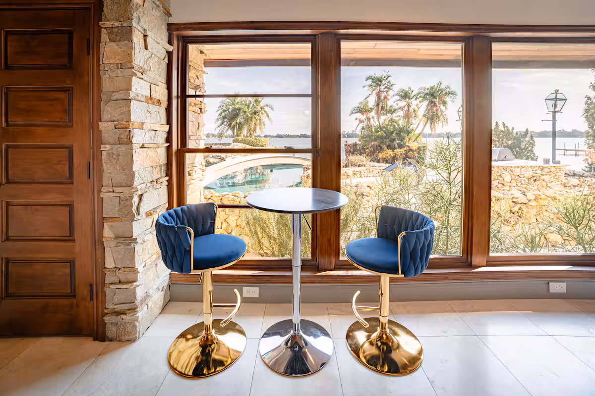 Sunlit reading corner with a pair of blue armchairs