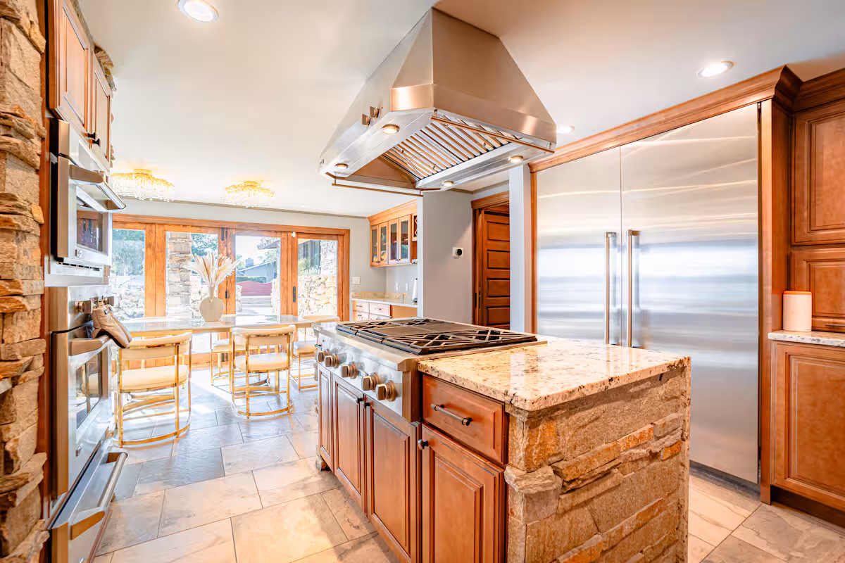 Chef's kitchen with granite island, pro cooktop, and cherry cabinetry