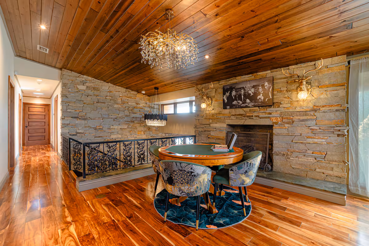 Round dining nook with chandelier and warm wood paneling